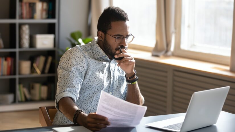 Man reviewing a long term disability denial letter at his desk
