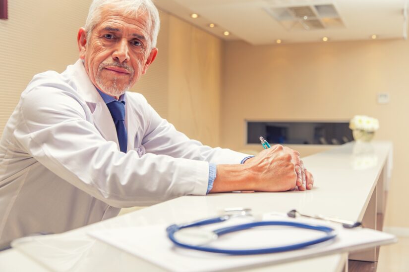 Doctor reviewing records with a patient file